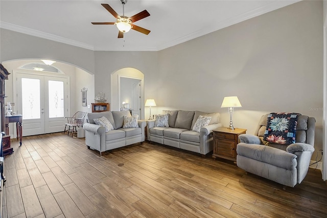 6008 Apex Way, Lady Lake, FL 32159 - living area featuring arched walkways, wood finished floors, a ceiling fan, french doors, and crown molding