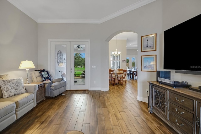 6008 Apex Way, Lady Lake, FL 32159 - entrance foyer with arched walkways, dark wood-type flooring, healthy amount of natural light, a chandelier, and ornamental molding