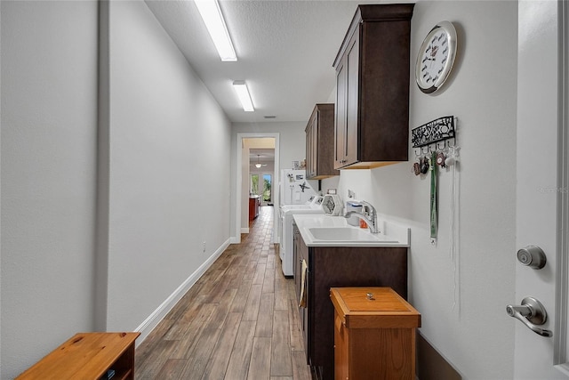6008 Apex Way, Lady Lake, FL 32159 - washroom with separate washer and dryer, cabinet space, wood finished floors, and baseboards
