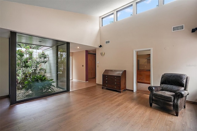 27113 Robertson Rd, Yalaha, FL 34797 - living area with light wood finished floors, baseboards, and a high ceiling