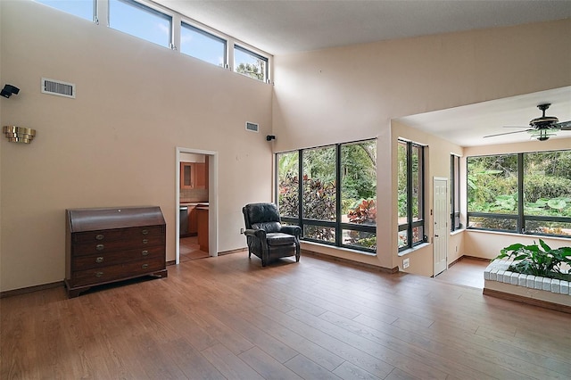 27113 Robertson Rd, Yalaha, FL 34797 - sitting room featuring plenty of natural light, ceiling fan, wood finished floors, and a high ceiling