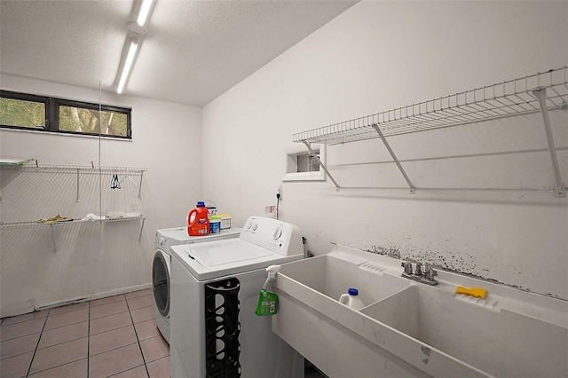 27113 Robertson Rd, Yalaha, FL 34797 - washroom featuring independent washer and dryer, light tile patterned floors, and a textured ceiling
