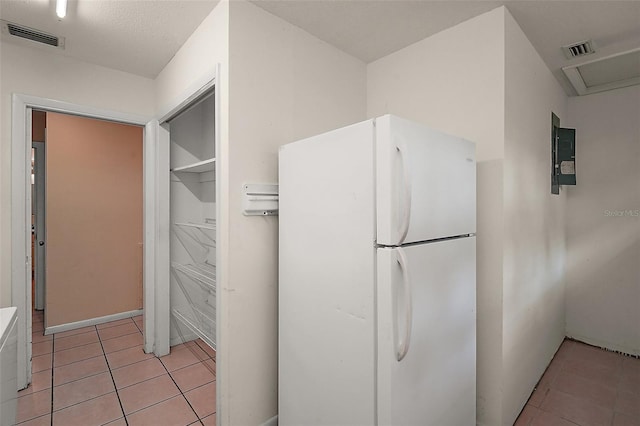 27113 Robertson Rd, Yalaha, FL 34797 - kitchen with freestanding refrigerator and light tile patterned floors