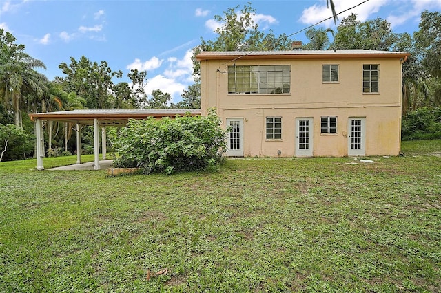 27113 Robertson Rd, Yalaha, FL 34797 - back of property with a lawn and stucco siding