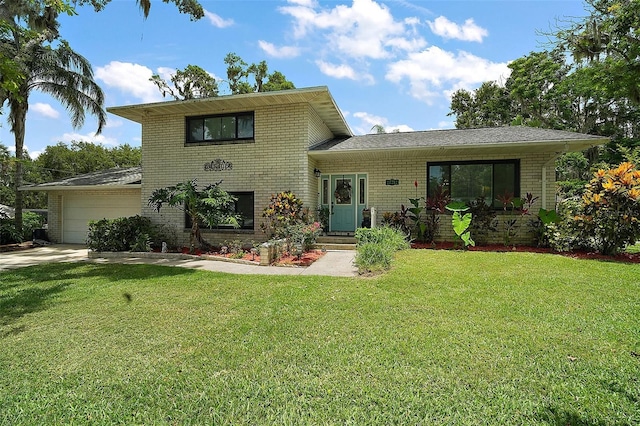 27212 Orange Ave, Yalaha, FL 34797 - split level home with brick siding, a front yard, driveway, and an attached garage