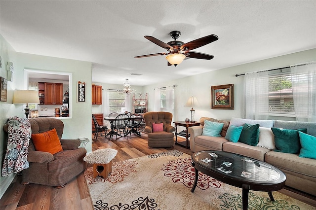 27212 Orange Ave, Yalaha, FL 34797 - living room featuring wood finished floors, ceiling fan, and a chandelier