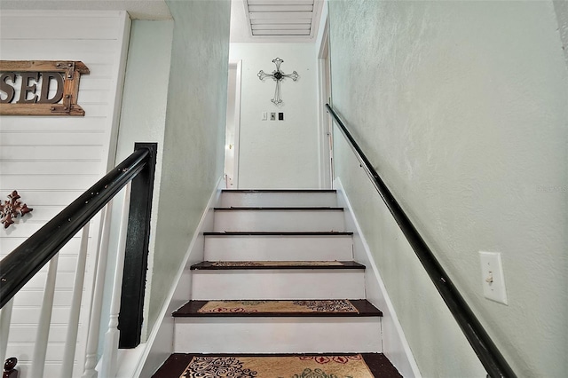 27212 Orange Ave, Yalaha, FL 34797 - staircase featuring a textured wall