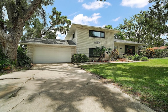 27212 Orange Ave, Yalaha, FL 34797 - split level home featuring brick siding, an attached garage, concrete driveway, and a front yard