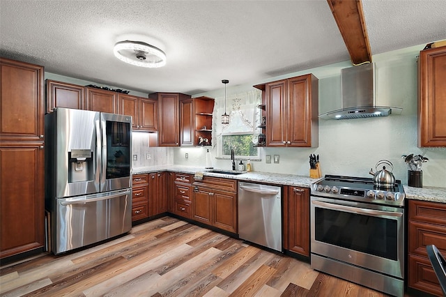 27212 Orange Ave, Yalaha, FL 34797 - kitchen with stainless steel appliances, wall chimney exhaust hood, open shelves, light wood finished floors, and a textured ceiling