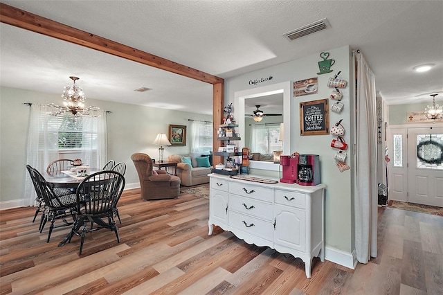 27212 Orange Ave, Yalaha, FL 34797 - dining area featuring a chandelier, plenty of natural light, light wood-style floors, beamed ceiling, and ceiling fan