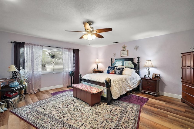 27212 Orange Ave, Yalaha, FL 34797 - bedroom with light wood-type flooring, a ceiling fan, and a textured ceiling