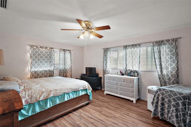 27212 Orange Ave, Yalaha, FL 34797 - bedroom featuring wood finished floors and ceiling fan