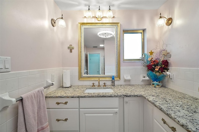 27212 Orange Ave, Yalaha, FL 34797 - bathroom featuring vanity, tile walls, and wainscoting
