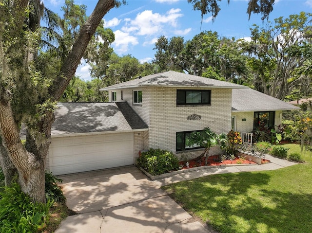 27212 Orange Ave, Yalaha, FL 34797 - split level home with brick siding, an attached garage, driveway, and a front yard