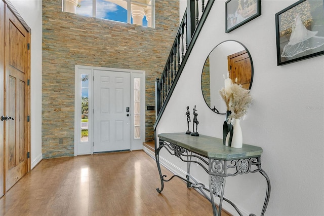 17300 Summer Sun Ct, Clermont, FL 34711 - entrance foyer featuring stairs, a towering ceiling, wood finished floors, and baseboards