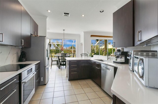 17300 Summer Sun Ct, Clermont, FL 34711 - kitchen featuring a sink, appliances with stainless steel finishes, light countertops, recessed lighting, and light tile patterned floors
