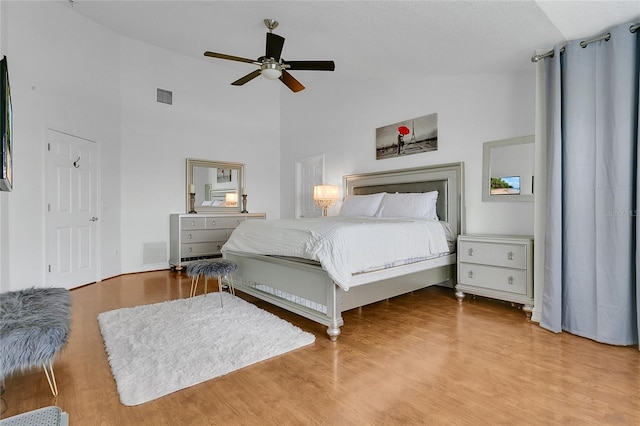 17300 Summer Sun Ct, Clermont, FL 34711 - bedroom featuring wood finished floors, high vaulted ceiling, ceiling fan, and baseboards