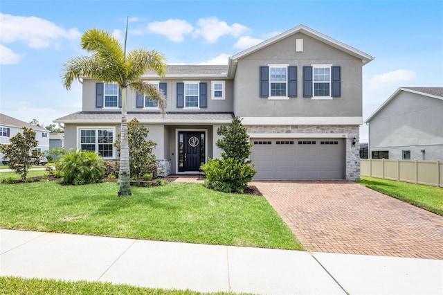 391 Cheeota Ct, Minneola, FL 34715 - view of front of house with decorative driveway, stucco siding, and a garage