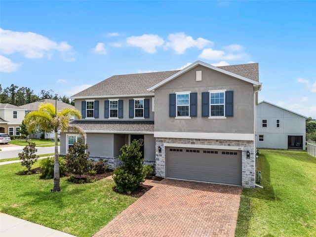 391 Cheeota Ct, Minneola, FL 34715 - traditional home featuring stucco siding, decorative driveway, an attached garage, a front yard, and stone siding