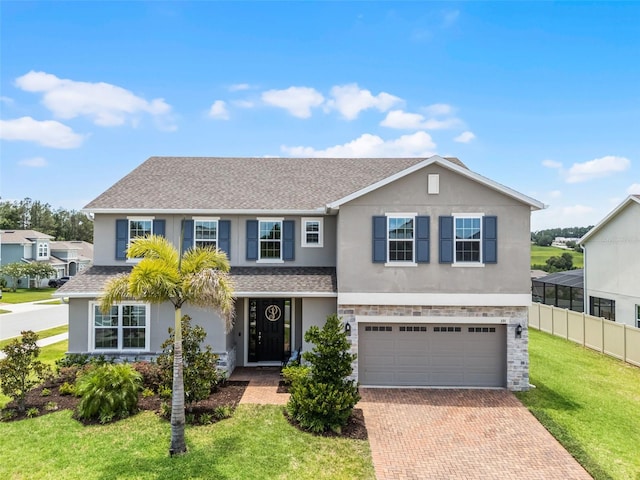 391 Cheeota Ct, Minneola, FL 34715 - traditional-style house featuring stucco siding, decorative driveway, a shingled roof, and an attached garage