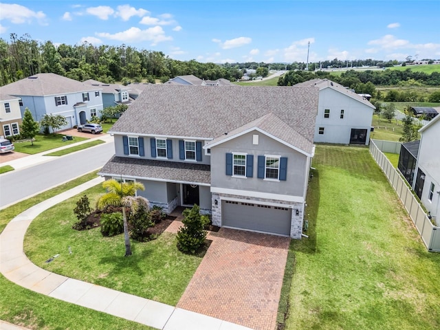 391 Cheeota Ct, Minneola, FL 34715 - traditional-style home with stucco siding, decorative driveway, an attached garage, roof with shingles, and a residential view