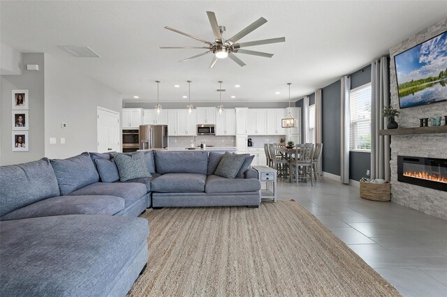 391 Cheeota Ct, Minneola, FL 34715 - living room featuring ceiling fan, light tile patterned floors, a fireplace, and recessed lighting