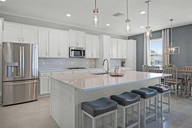 391 Cheeota Ct, Minneola, FL 34715 - kitchen featuring stainless steel appliances, tasteful backsplash, light tile patterned floors, recessed lighting, and a center island with sink