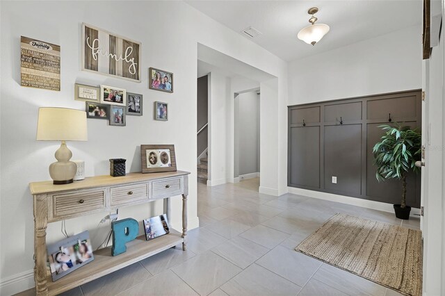 391 Cheeota Ct, Minneola, FL 34715 - hall with stairway and tile patterned floors