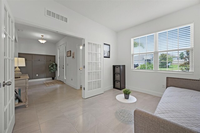 391 Cheeota Ct, Minneola, FL 34715 - bedroom featuring french doors and light tile patterned floors