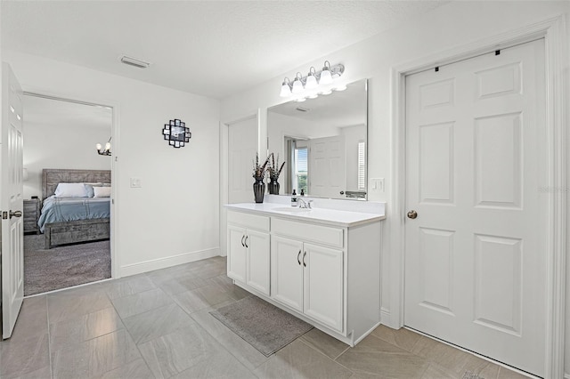 391 Cheeota Ct, Minneola, FL 34715 - bathroom featuring vanity, connected bathroom, and a chandelier