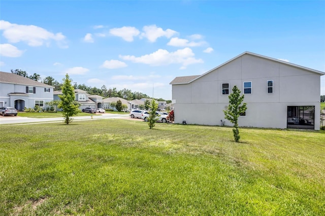 391 Cheeota Ct, Minneola, FL 34715 - view of green lawn featuring a residential view