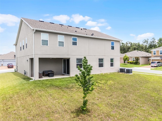 391 Cheeota Ct, Minneola, FL 34715 - rear view of house with stucco siding, a lawn, a patio, and an outdoor hangout area