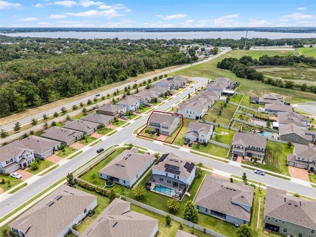 391 Cheeota Ct, Minneola, FL 34715 - aerial perspective of suburban area featuring a large body of water and property parcel outlined