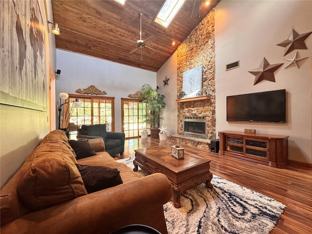 3664 SE 45th Pl, Ocala, FL 34480 - living area with high vaulted ceiling, a skylight, wood finished floors, wooden ceiling, and a fireplace