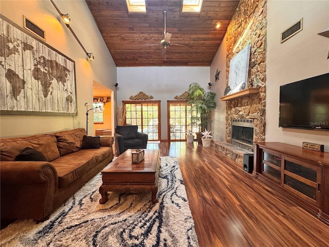 3664 SE 45th Pl, Ocala, FL 34480 - living area with high vaulted ceiling, wooden ceiling, a stone fireplace, wood finished floors, and a ceiling fan