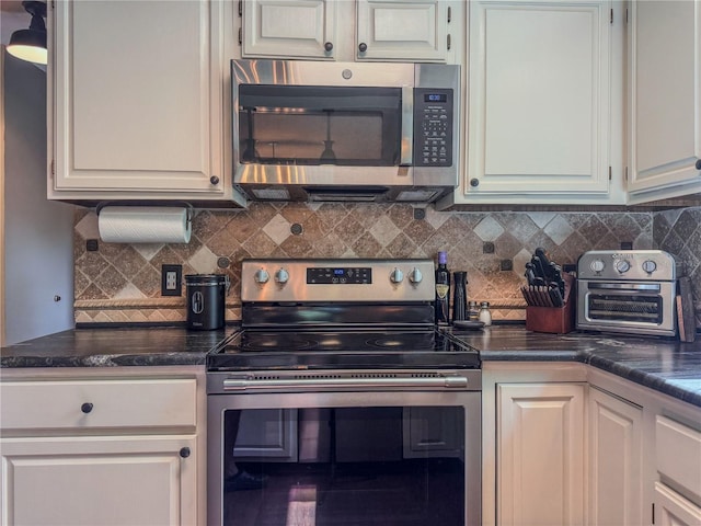 3664 SE 45th Pl, Ocala, FL 34480 - kitchen with appliances with stainless steel finishes, dark countertops, and backsplash