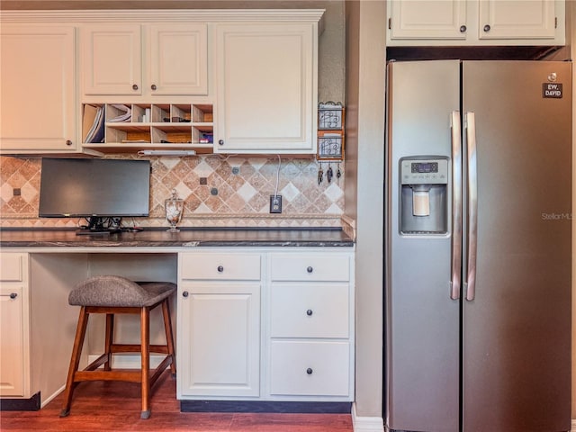 3664 SE 45th Pl, Ocala, FL 34480 - kitchen with stainless steel fridge with ice dispenser, dark countertops, tasteful backsplash, and dark wood finished floors
