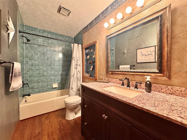 3664 SE 45th Pl, Ocala, FL 34480 - full bathroom with wood finished floors, vanity, shower / bathtub combination with curtain, and a textured ceiling