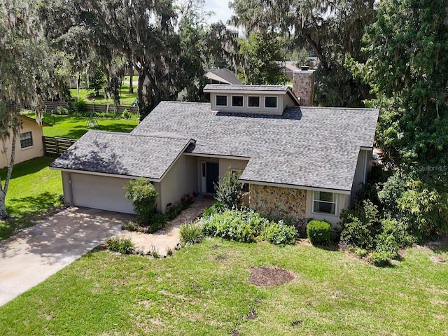 3664 SE 45th Pl, Ocala, FL 34480 - mid-century modern home with a garage, a chimney, roof with shingles, stone siding, and concrete driveway