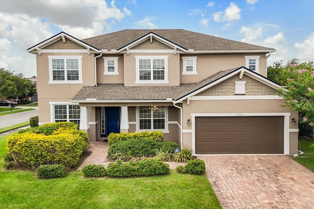 752 Sandy Bar Dr, Winter Garden, FL 34787 - view of front facade featuring stucco siding, decorative driveway, a front yard, an attached garage, and roof with shingles