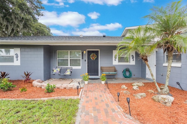 11750 Watts Ct, Tavares, FL 32778 - view of front of property featuring a porch, a shingled roof, and concrete block siding