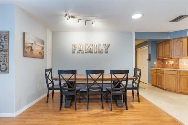 11750 Watts Ct, Tavares, FL 32778 - dining area featuring light wood-style flooring and baseboards