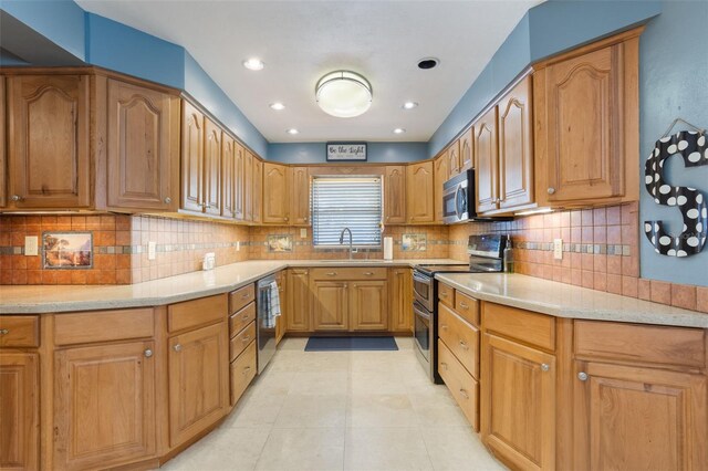 11750 Watts Ct, Tavares, FL 32778 - kitchen with appliances with stainless steel finishes, tasteful backsplash, light tile patterned flooring, recessed lighting, and brown cabinets