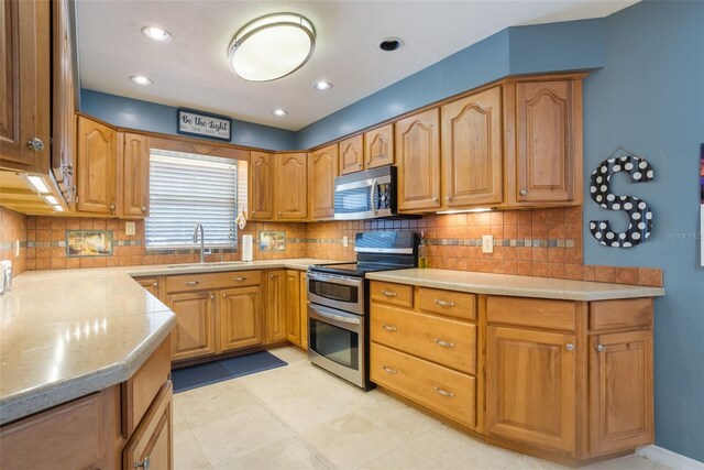 11750 Watts Ct, Tavares, FL 32778 - kitchen featuring appliances with stainless steel finishes, light countertops, backsplash, and recessed lighting