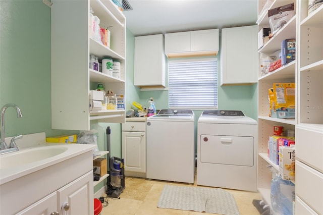 11750 Watts Ct, Tavares, FL 32778 - laundry room with cabinet space, washer and dryer, and light tile patterned floors
