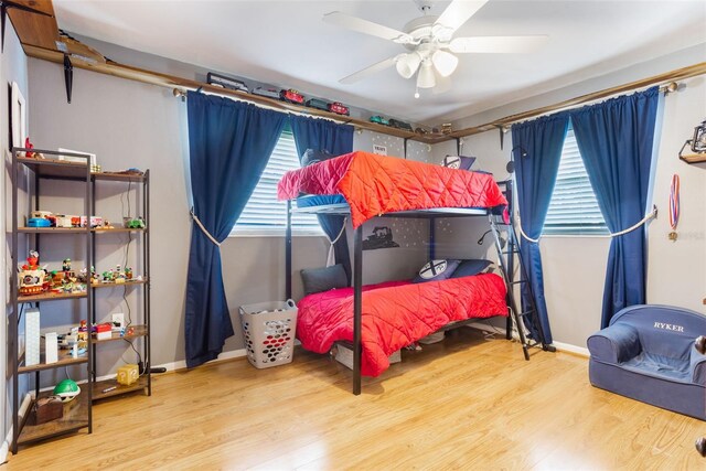11750 Watts Ct, Tavares, FL 32778 - bedroom featuring multiple windows, wood finished floors, and ceiling fan