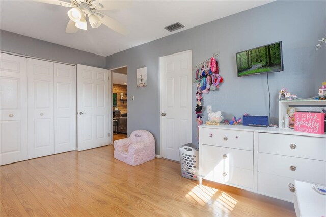 11750 Watts Ct, Tavares, FL 32778 - bedroom with light wood-style flooring, a closet, and a ceiling fan
