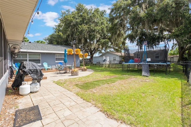 11750 Watts Ct, Tavares, FL 32778 - fenced backyard with a trampoline and a patio