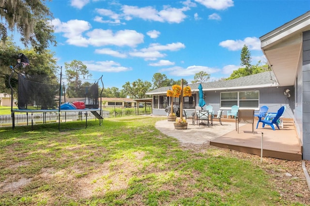 11750 Watts Ct, Tavares, FL 32778 - view of yard featuring a trampoline, a sunroom, and a patio area
