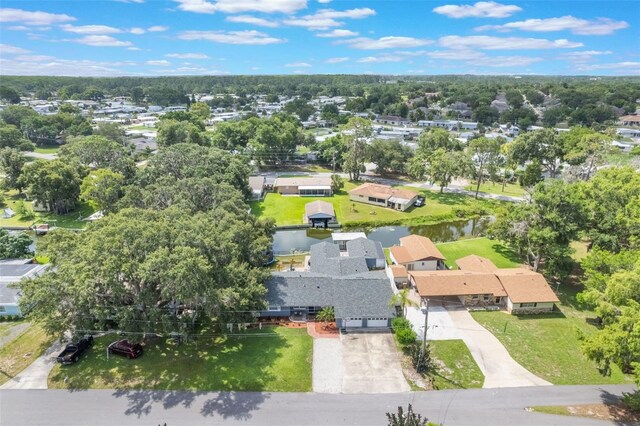 11750 Watts Ct, Tavares, FL 32778 - aerial view of residential area featuring a tree filled landscape and a large body of water